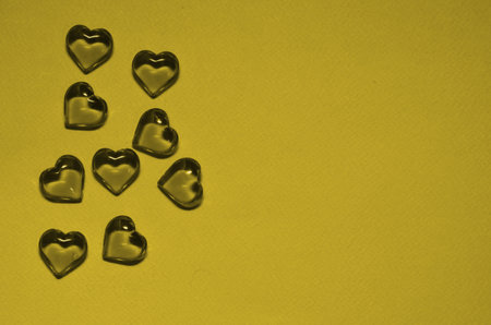 Glass little hearts on a colored background. Valentine's Day Greeting Cardの写真素材