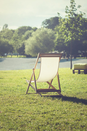 Deck chair in a grass near the beach, on a hot summer dayの写真素材