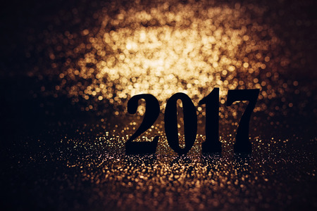 Happy New Year creative holiday background - 2017 new year sign text written in black with golden...
