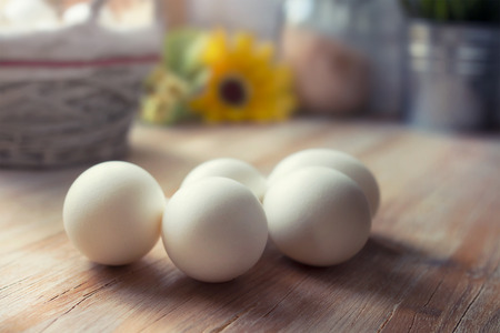 White eggs on kitchen table, Easter breakfast concept
