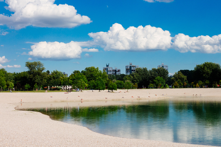 Beach by the lake on a bright and sunny dayの写真素材