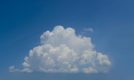 Beautiful, big fluffy white cloud on a bright blue sky