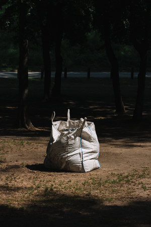 White garbage bag left in the parkの写真素材