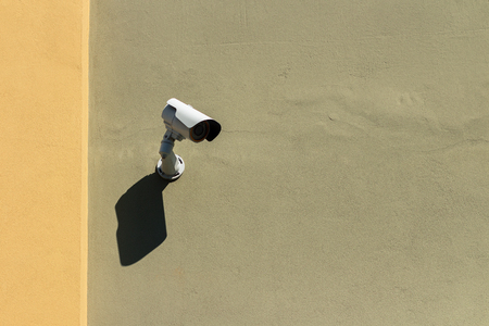 Security camera on a green and yellow house facade