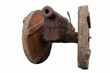 Old vintage gunpowder cannon on wooden carriage with large wheels isolated on white backgroundの写真素材