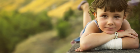 Five years old girl playing in countryside.の写真素材