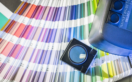 Color management in printing process with magnifying glass, color swatches and densitometerの写真素材