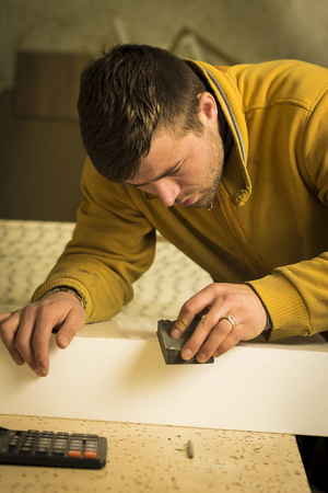 Man doing some carpentry work in a workshop. の写真素材