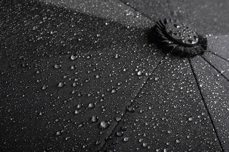 Black waterproof umbrella texture with water dropletsの写真素材