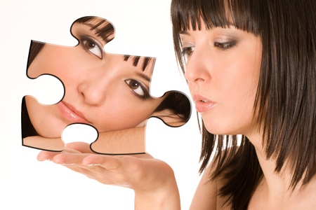 Beautiful girl with piece of puzzleの写真素材