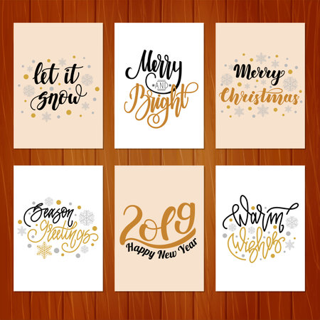 Set of christmas greeting cards with hand written lettering on wooden background.のイラスト素材