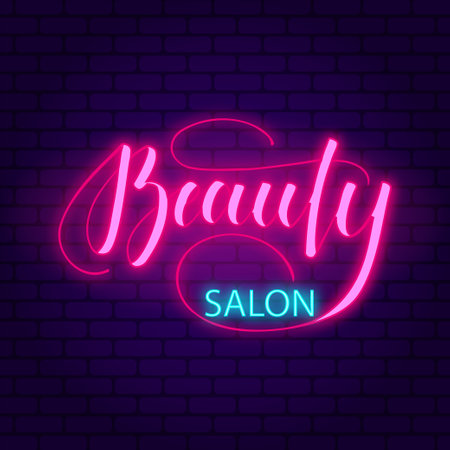 Beauty salon. Glowing pink neon incription on dark brick wall background.のイラスト素材