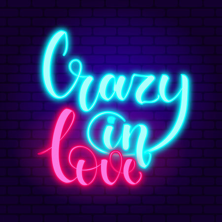 Crazy in love. Glowing blue and pink neon incription on dark brick wall background.のイラスト素材