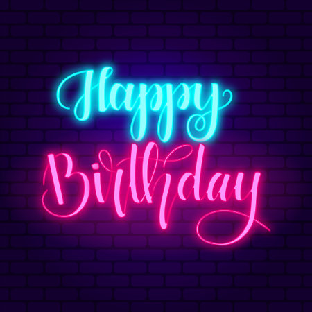 Happy birthday. Glowing pink neon and blue incription on dark brick wall background.のイラスト素材