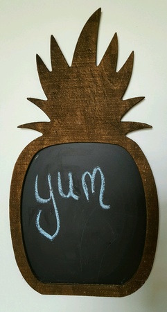 The word "yum" written in blue chalk on pineapple shaped blackboard.の素材