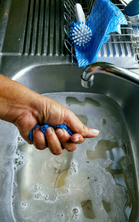 Cleaning chores, hand rinses dishcloth.の素材