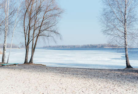 Early spring ice covered river bank landscapeの写真素材