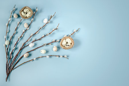Easter frame with pussy willow branches and colorful Easter eggs in birds nest, minimal Easter backgroundの写真素材
