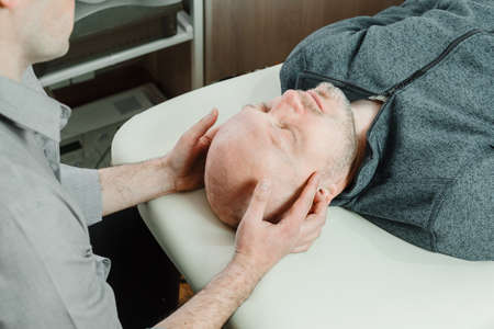 Ostheopatic treatment of a patient using CST gentle hands-on technique, central nervous system...