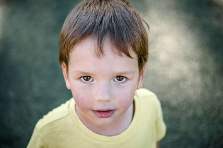 Top view portrait of a cute little boy in the football fieldの写真素材
