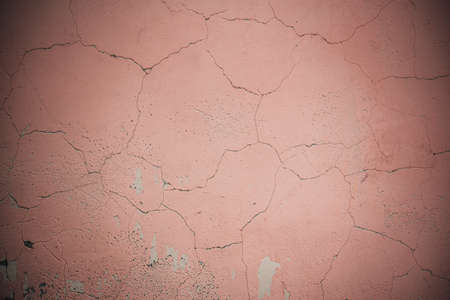 Old cracked pink peach wall backgroundの写真素材