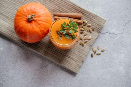 Freshly squeezed pumpkin juice with parsley and pumpkin seeds top viewの写真素材