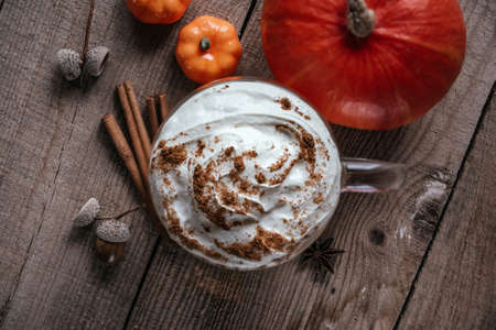 Autumn pumpkin spice hot drink on wooden background top viewの写真素材