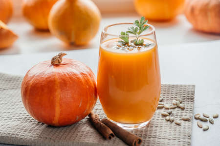 Freshly squeezed pumpkin juice with parsley and pumpkin seeds top viewの写真素材
