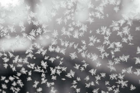 Windshield of the car covered with first frost, winter driving conditions