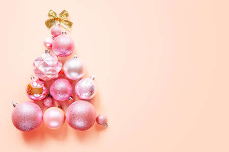 Innovative Christmas tree made of Christmas ornaments on pink backgroundの写真素材