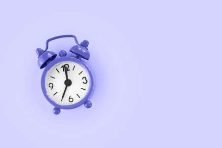 Purple alarm clock on purple background, very peri color of 2022の写真素材