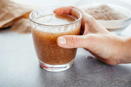 A glass of water soluble psyllium husk dietary fiber supplement, healthy diet morning routine