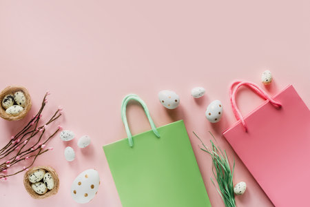 Easter shopping background with green and pink shopping bags with Easter eggs and birds nest on pink backgroundの写真素材