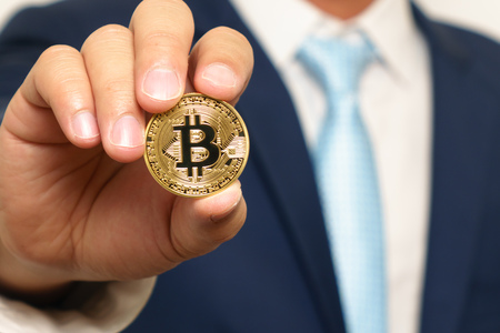 Businessman holding bit-coinの写真素材