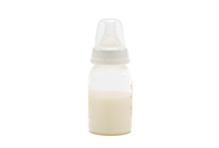 Fresh breast milk in the bottle on whiteの写真素材