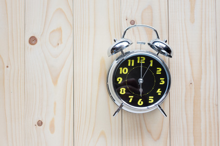 Clock retro style show 6 o'clock on wood backgroundの写真素材