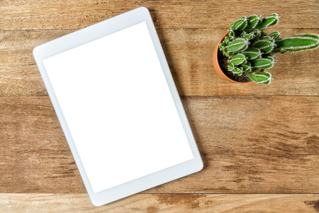 Blank modern digital tablet on a wooden desk. Top viewの写真素材