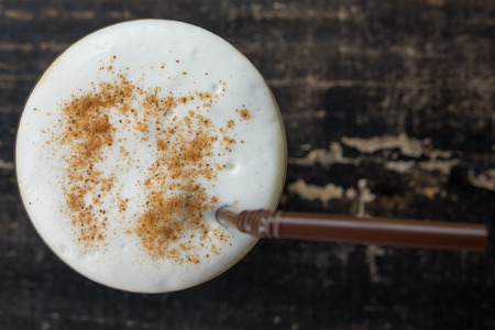 a cup of coffee on wood table