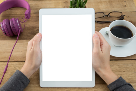 woman hands holding empty screen of tablet on wood desk work.