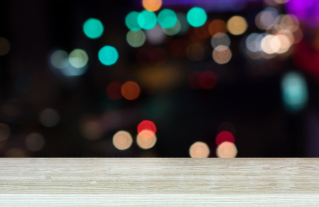 Empty top wooden table and blur with Lights of Traffic jam in city. For product display