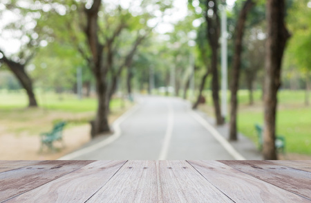 Empty perspective white wood over blurred trees with bokeh background, for product displayの写真素材