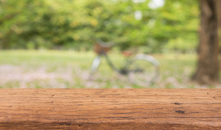Wood table top on blur green abstract background for display your productsの写真素材