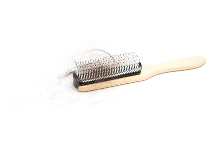 Comb with hair loss problem on white backgroundの写真素材