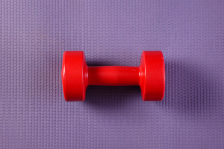 Purple yoga mat with dumbbell