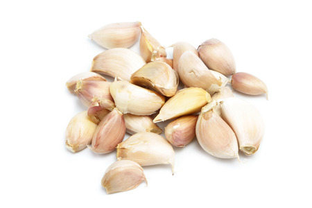 garlic cloves isolated on whiteの写真素材