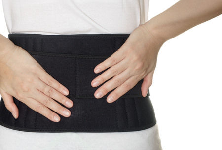 woman wearing back support belt isolated on whiteの写真素材