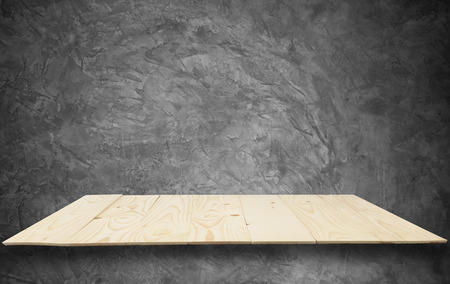 Wooden shelves on raw Cement wall in loft Style wall for backgroundの写真素材