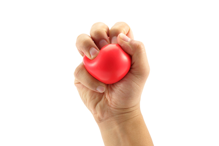 A man hand squeezing a stress ball  on white backgroundの写真素材