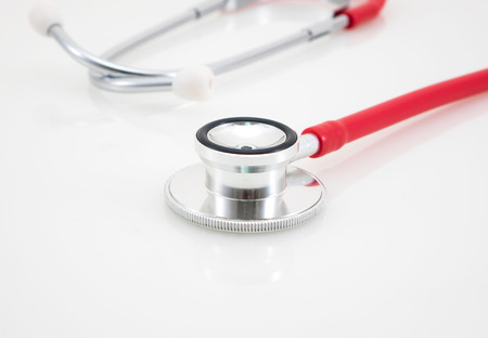 Red medical stethoscope isolated over the white backgroundの写真素材