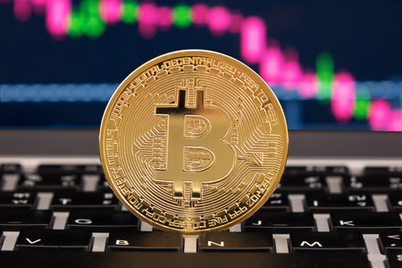 Bitcoin coin symbol on laptop with Line chart backgroundの写真素材